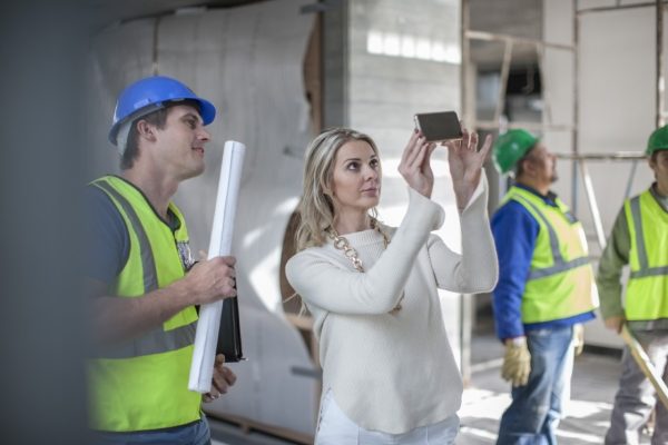 Construction workers and woman on construction site